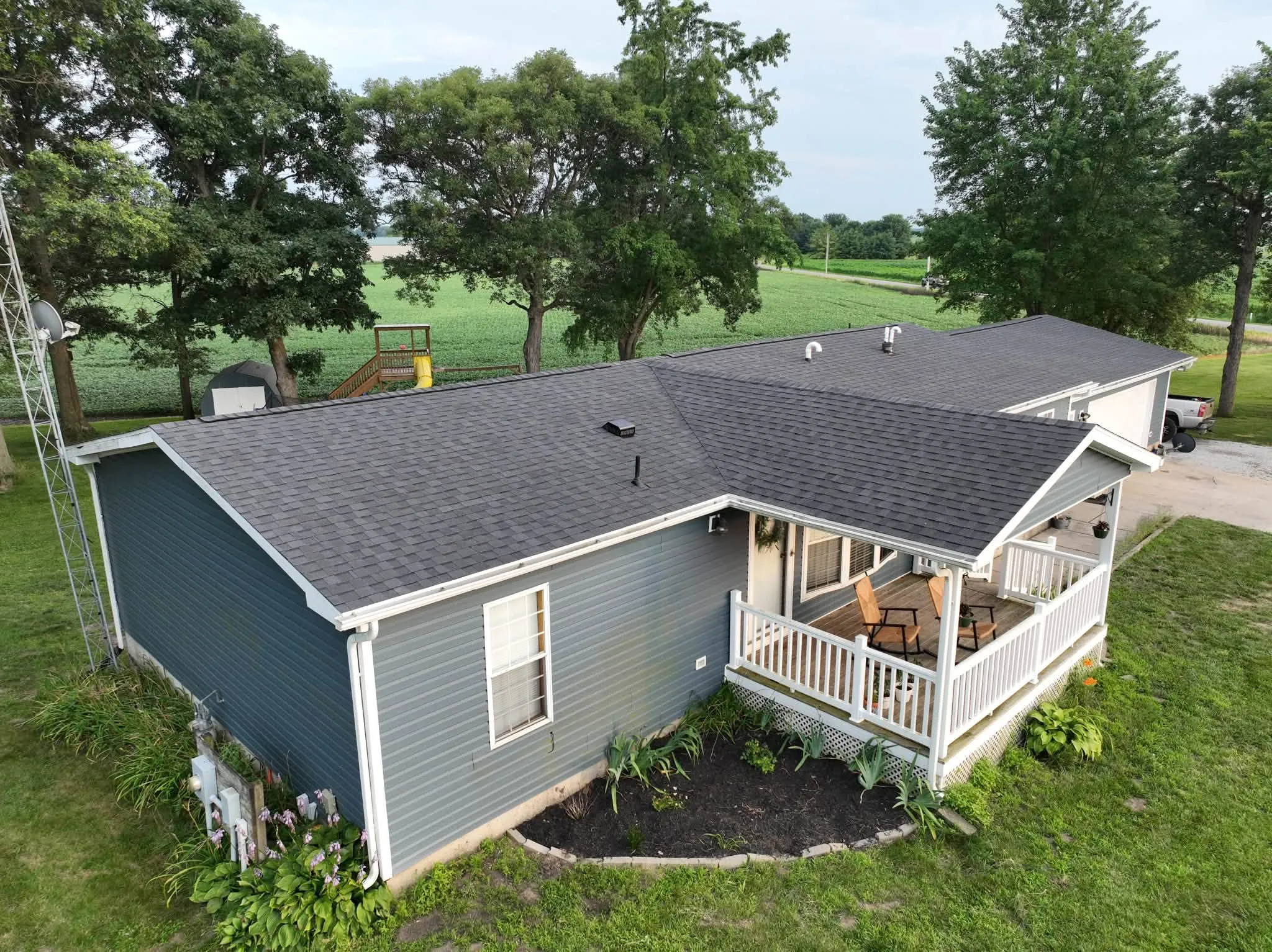 The finished Winamac home from the air, with its new Moire Black roof above the covered porch and open field behind