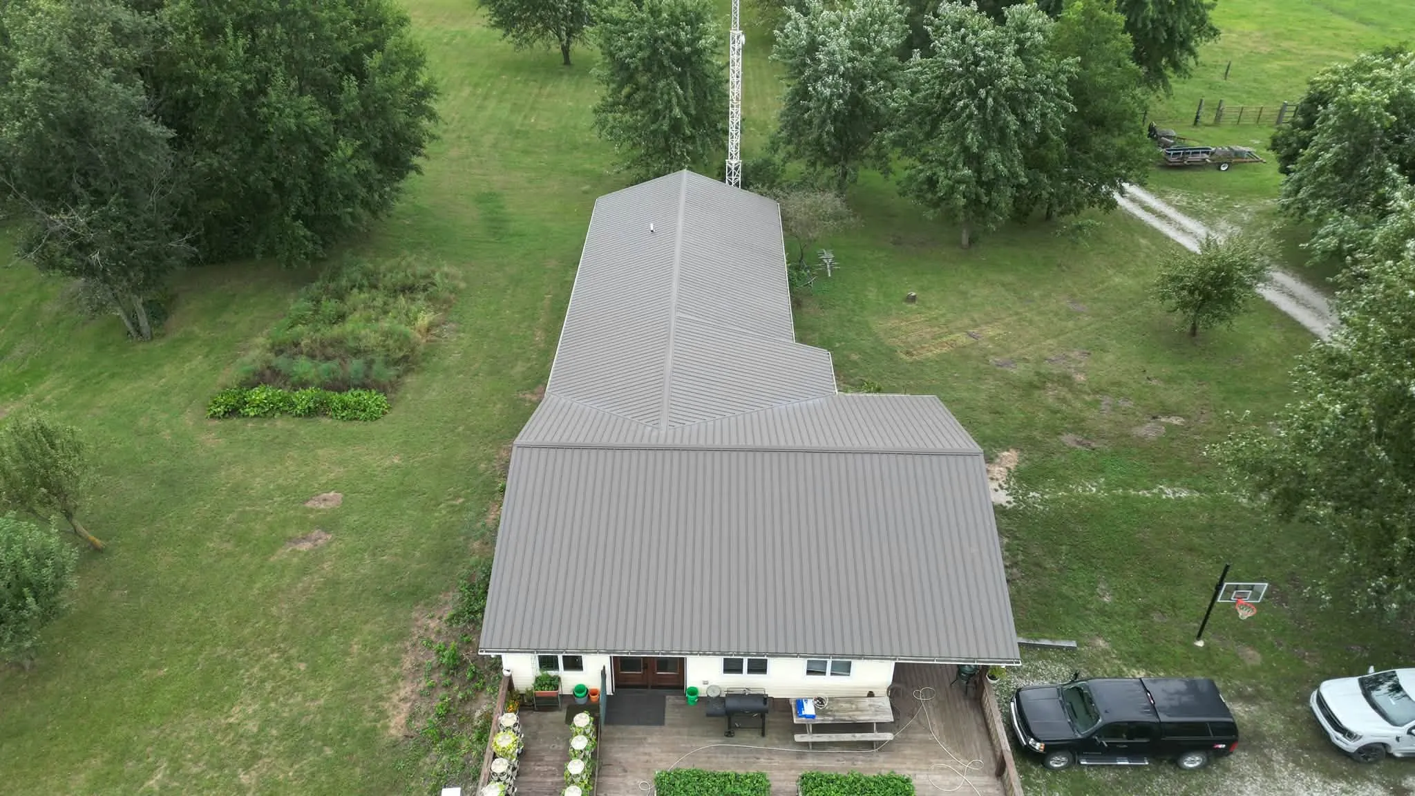 The front of the house from above, with the gable end over the patio and the long main roof behind it