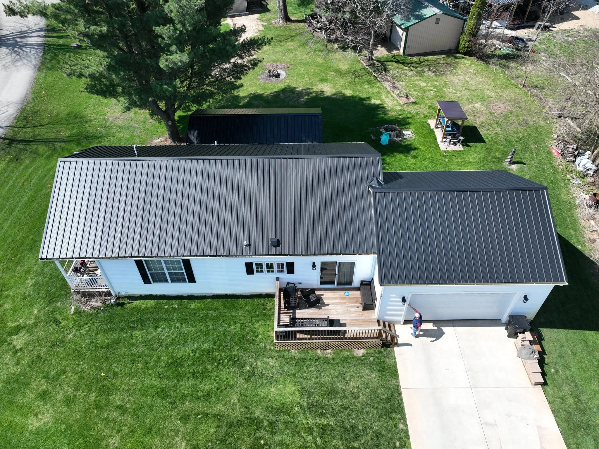 The back of the house from the air, with the metal panels running from ridge to eave above the deck