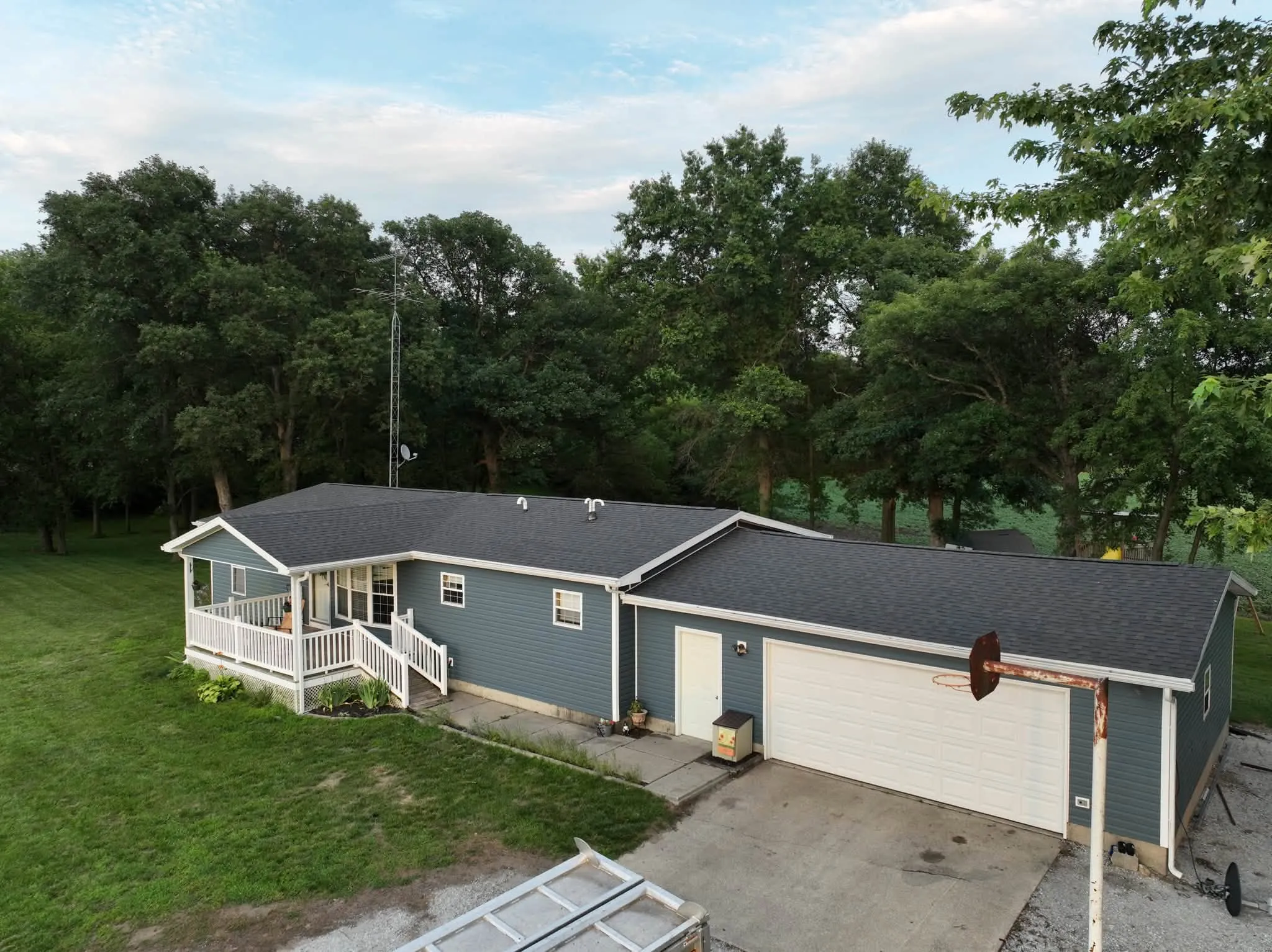 The house and attached garage from the driveway side, with the new roof running the full length