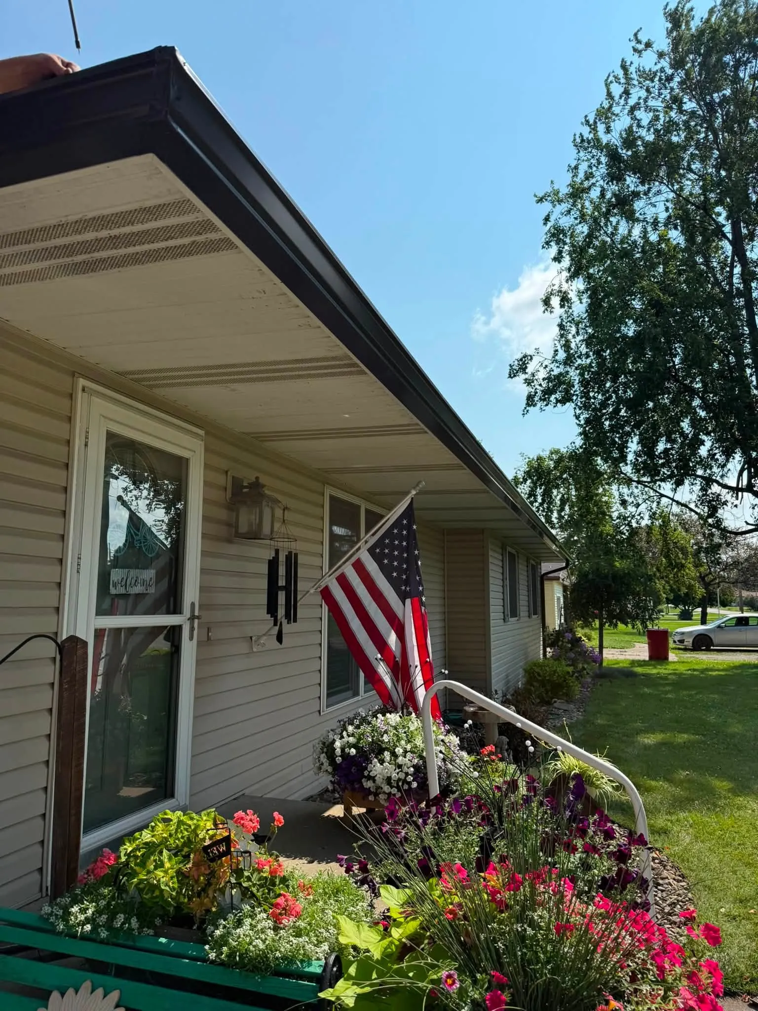 The new gutter running along the eave above the front entry
