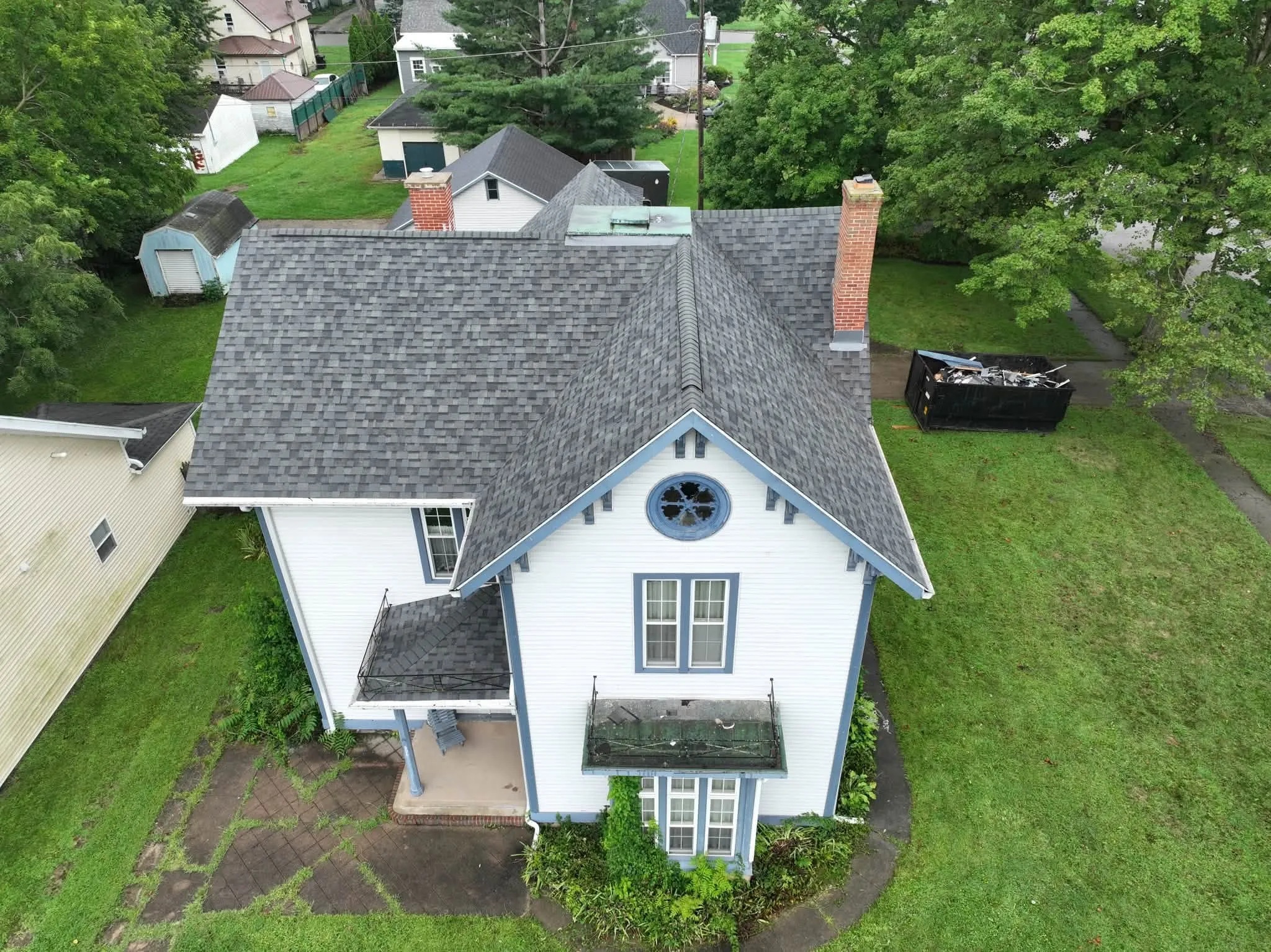 The front of the house from above, with the new roof over the gables and the small porch