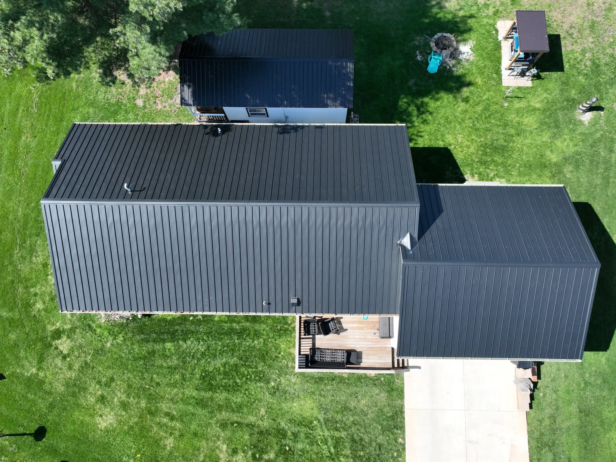 Straight-down view of the completed roof, showing the long main run and the garage wing meeting at a right angle