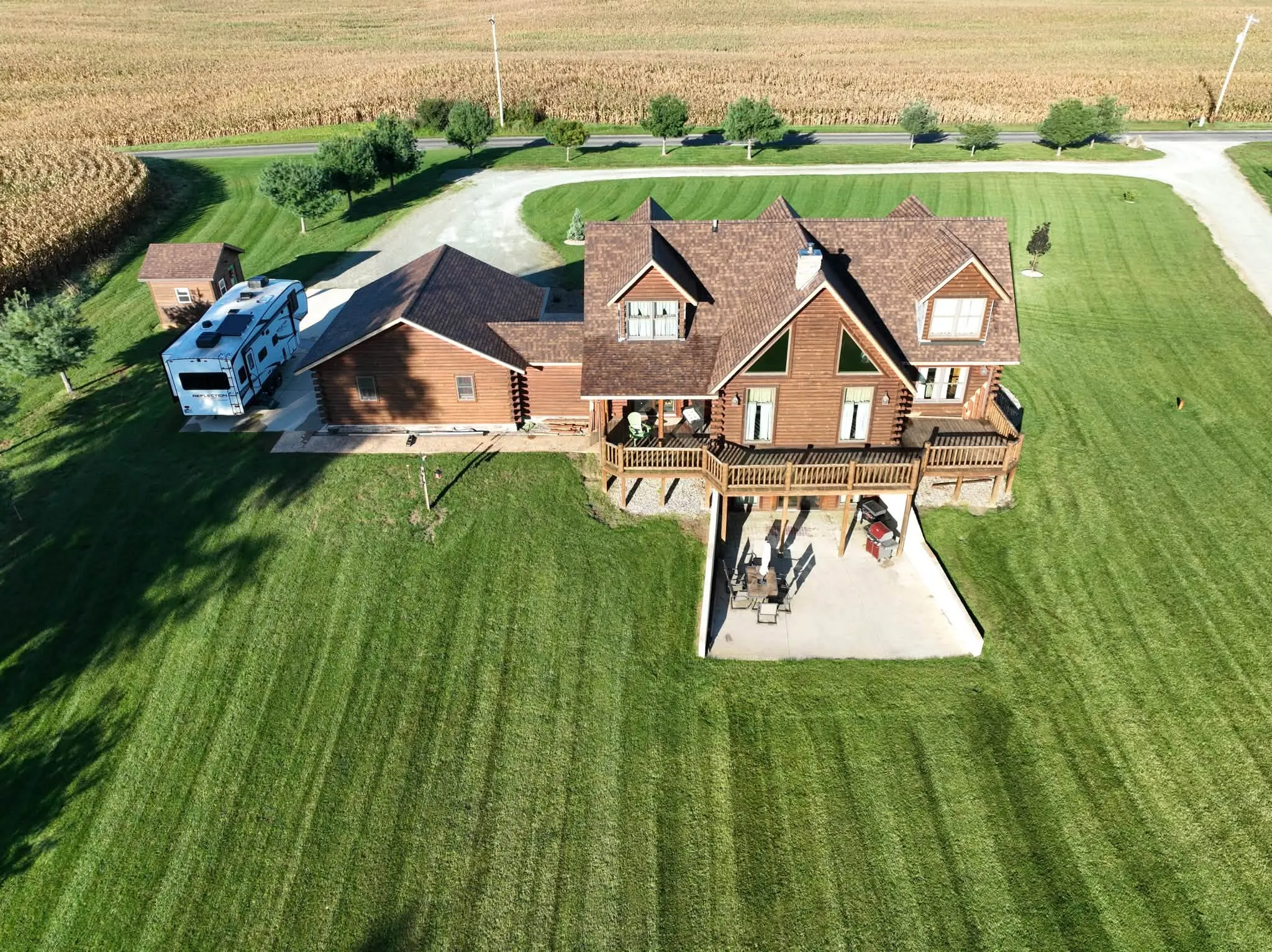 The back of the house from above, with the tall gable and its windows, the decks, and the patio below