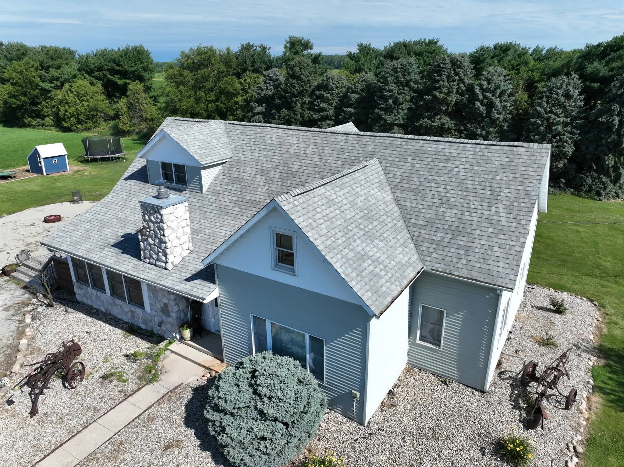 The house from the side, showing the new roof across the dormer, the sunroom and the side gable