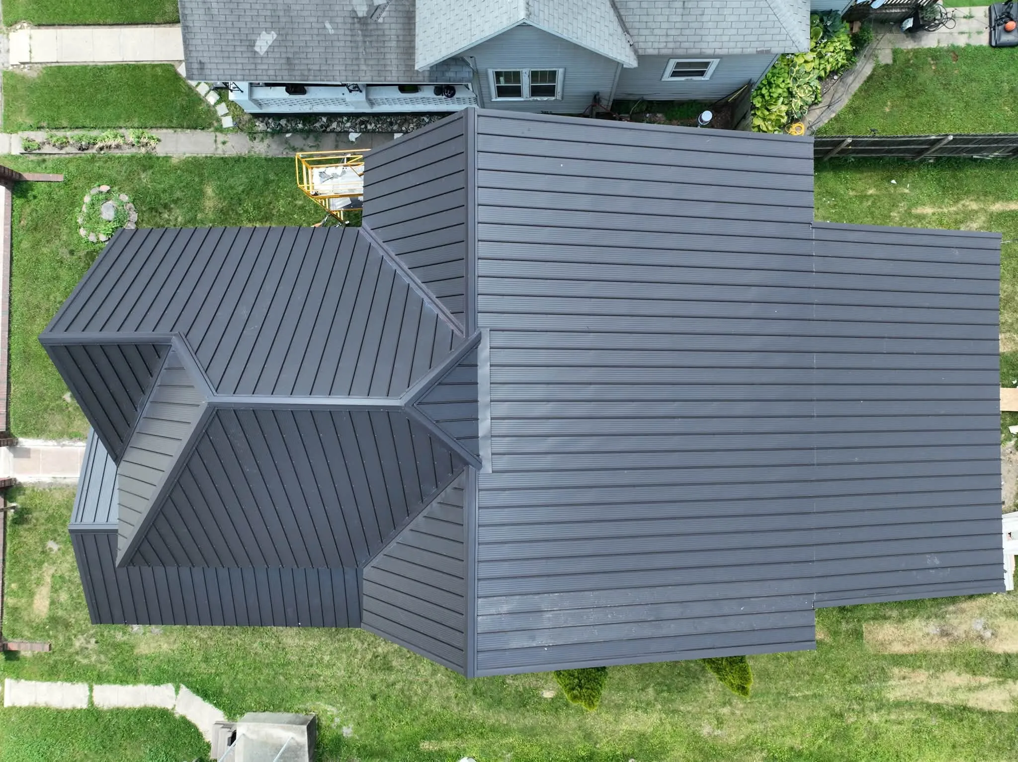 Close overhead view of the Dark Bronze panels, showing the ribs running up to the ridge and the hips at the gable