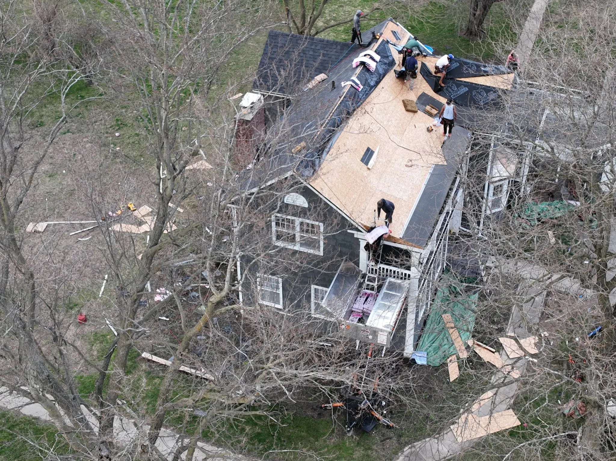 Overhead view mid-job, with old shingles on one section and new decking on another
