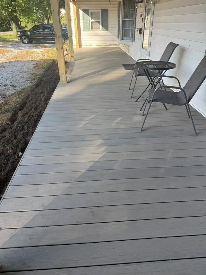 Close view of the new gray deck boards running the length of the front of the house