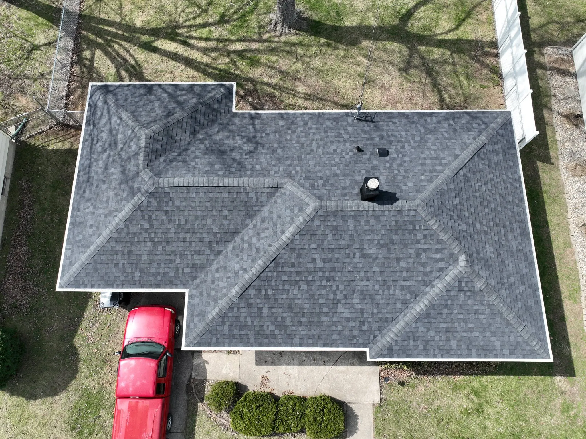 Straight-down view of the finished shingle roof, showing the hips running to each corner