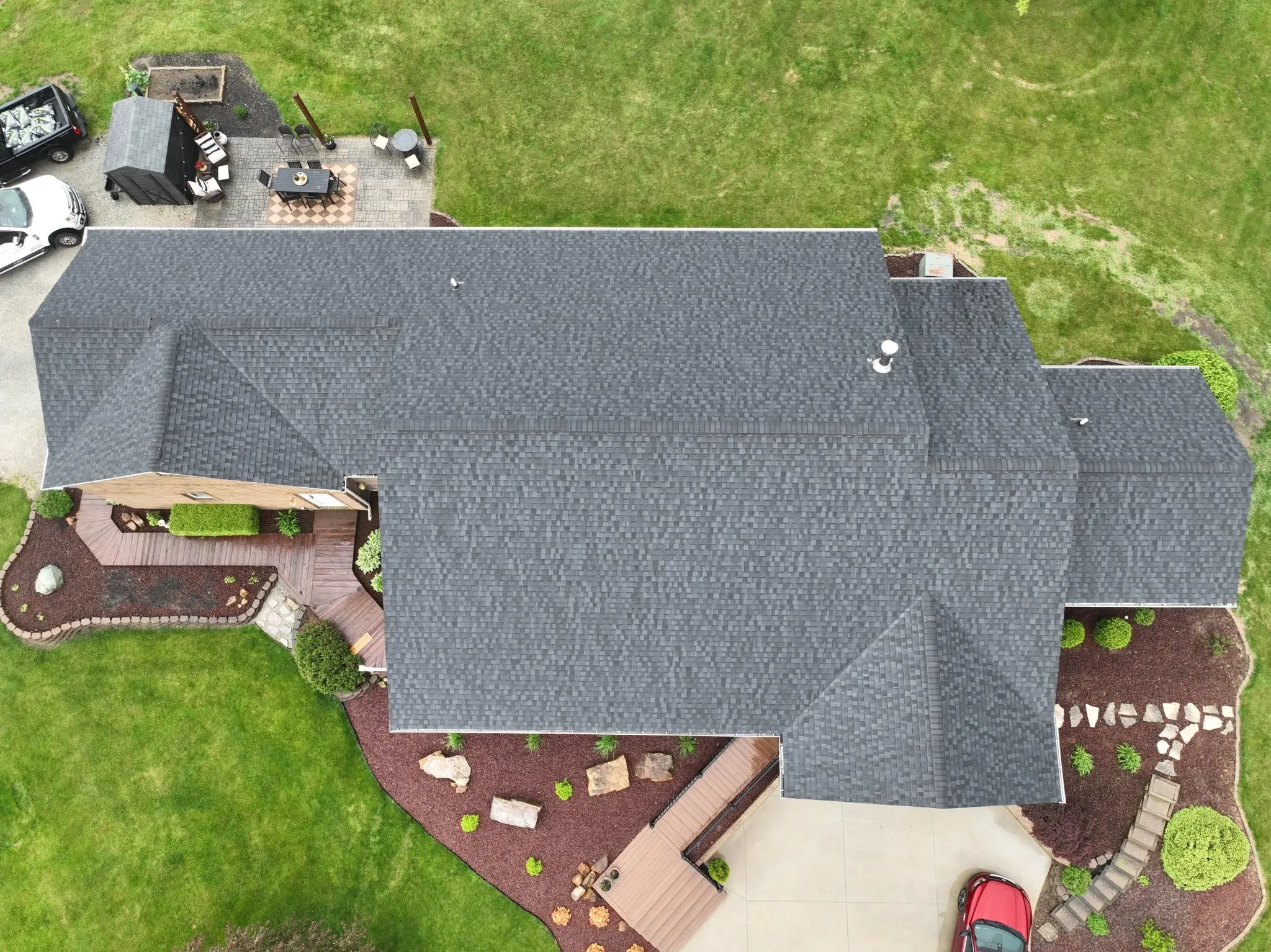 Straight-down view of the completed roof, showing the hips and valleys across the main run and the wings