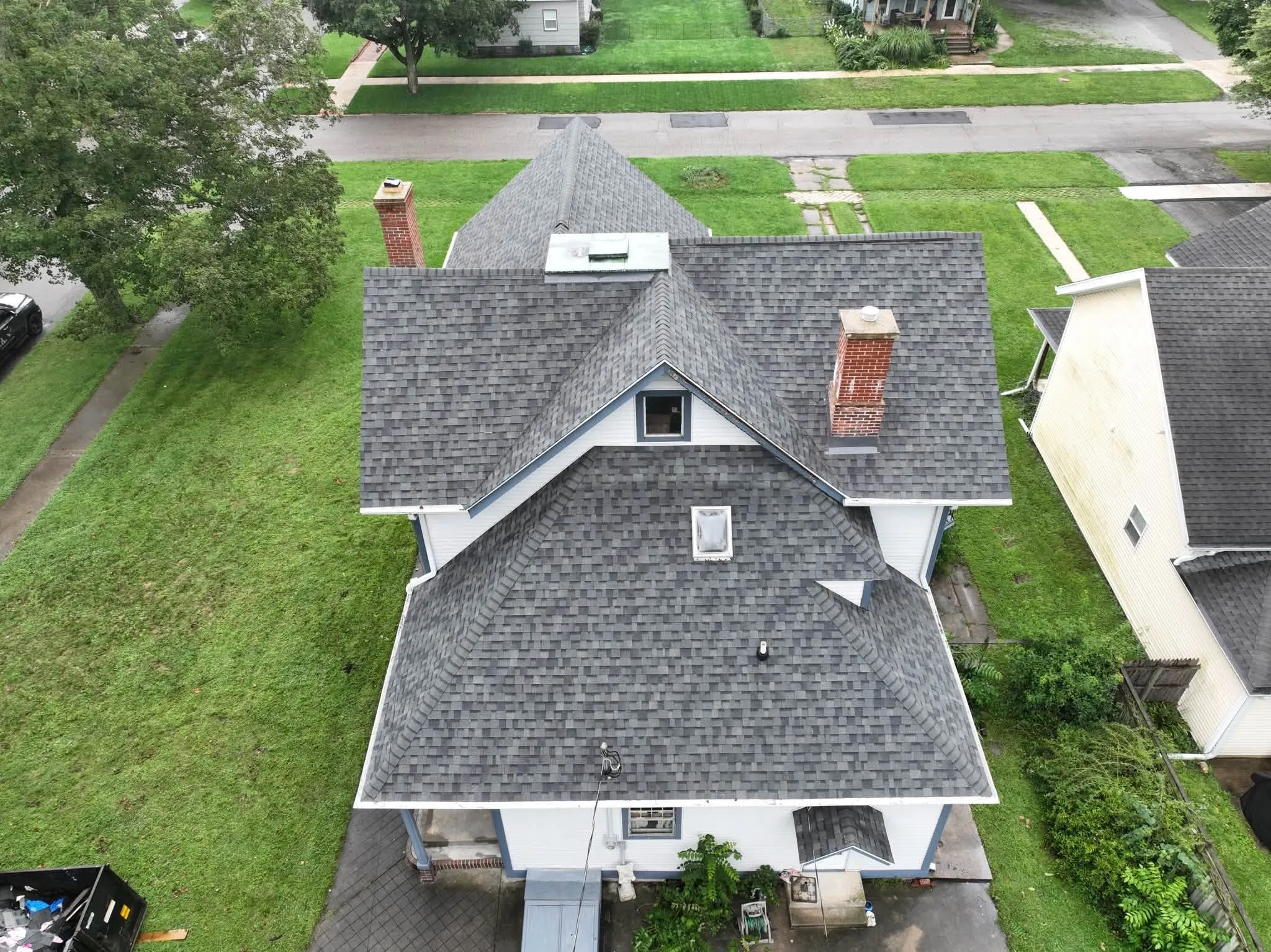 Looking down over the back of the house, with both chimneys and the roof sections stepping down
