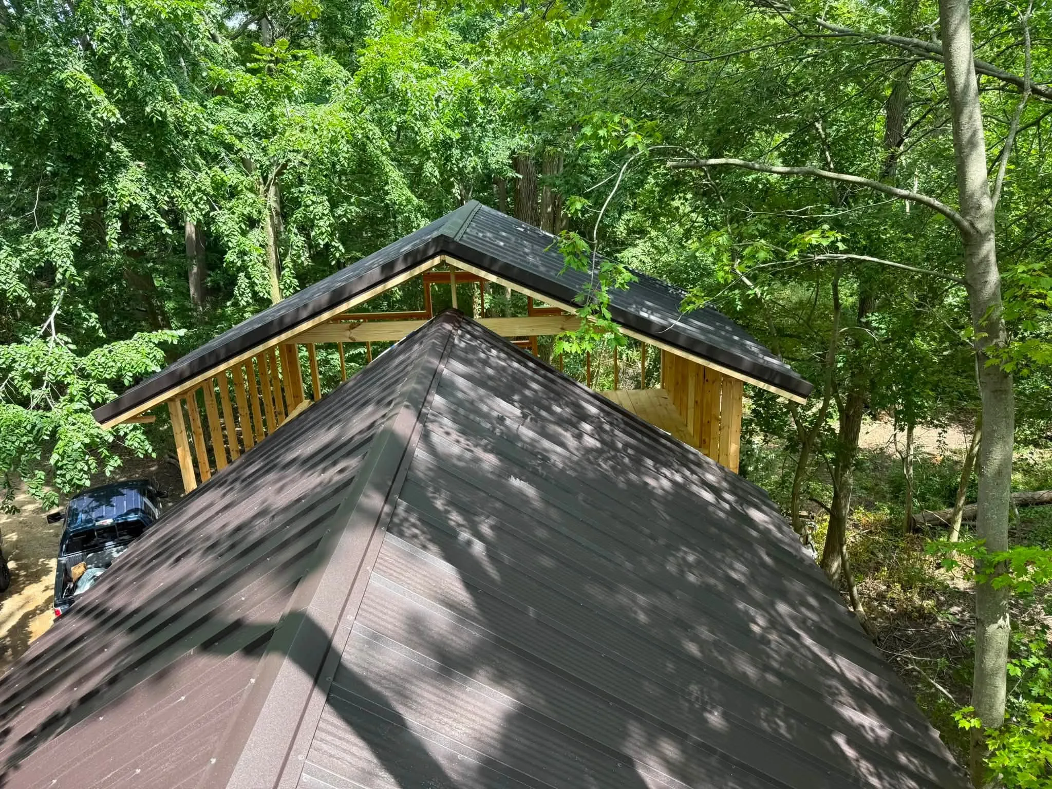Another view along the lower ridge, with the gable framing of the upper section behind it and the woods all around