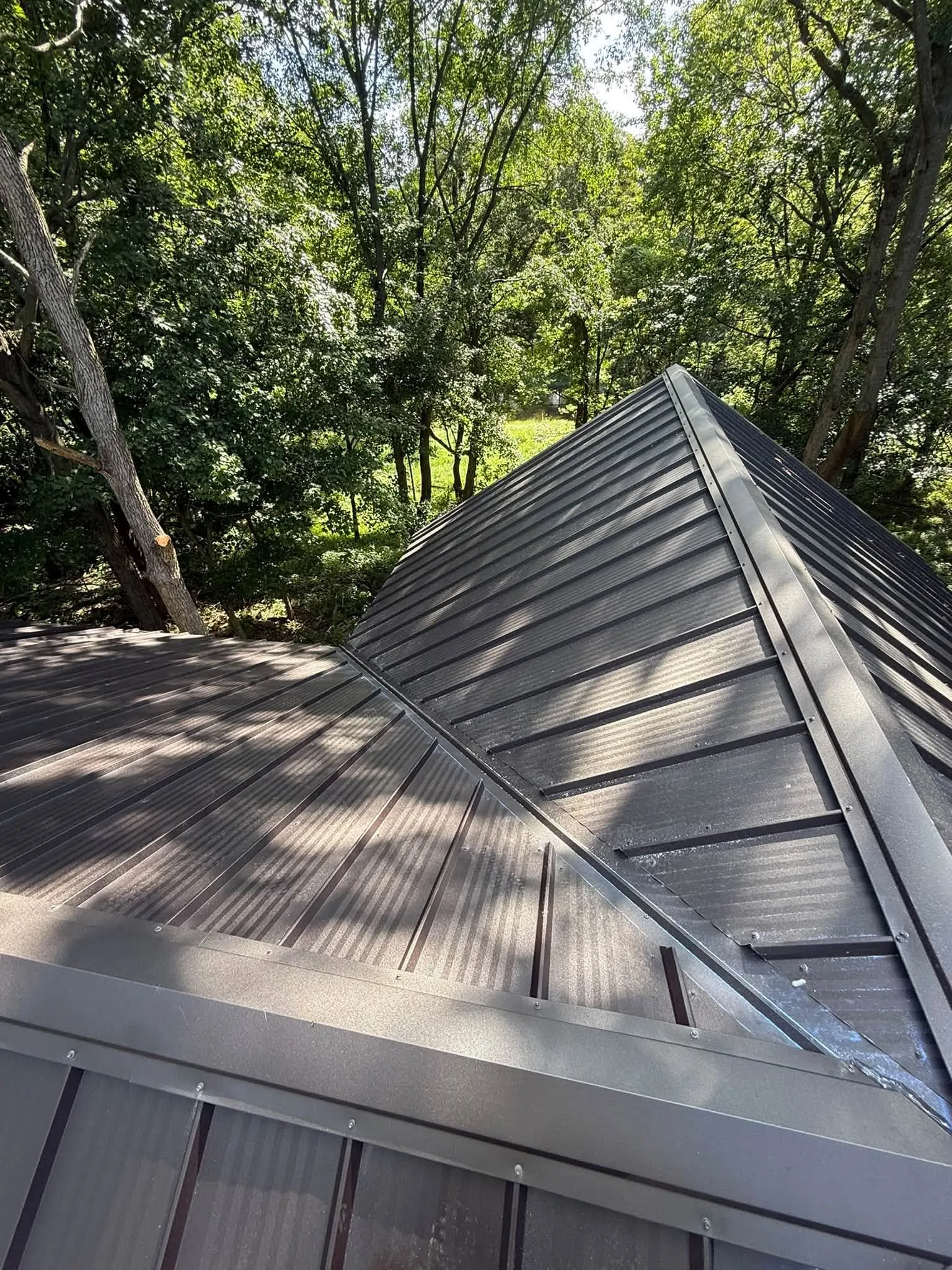 The valley where the two roof sections meet, with the panels running into it from both sides