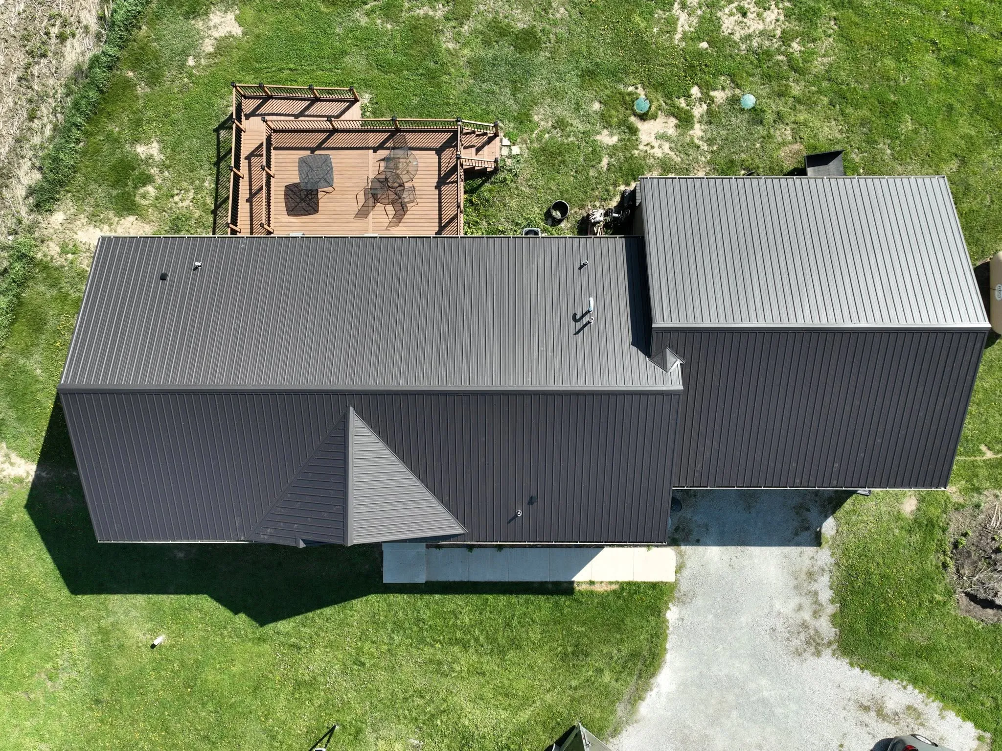 Straight-down view of the new metal roof running across the house and the attached garage
