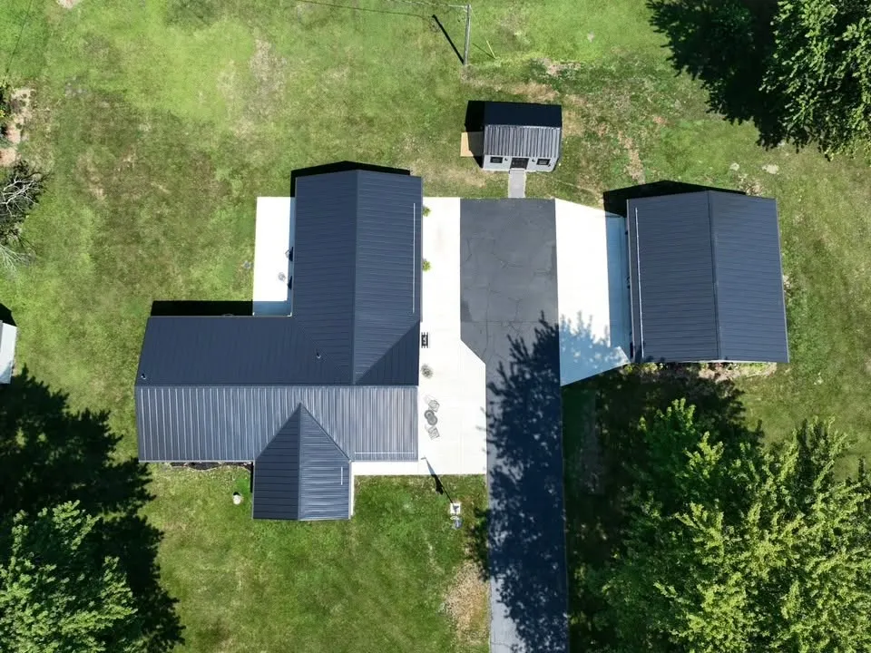 Straight-down view of the house roof, with the porch gable on the front and the seams running up to each hip