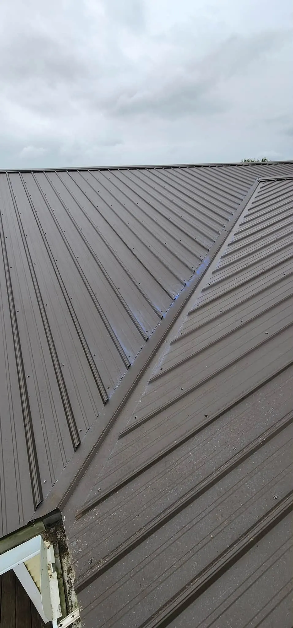 Close view along a hip where two slopes meet, with the trim fastened down its length