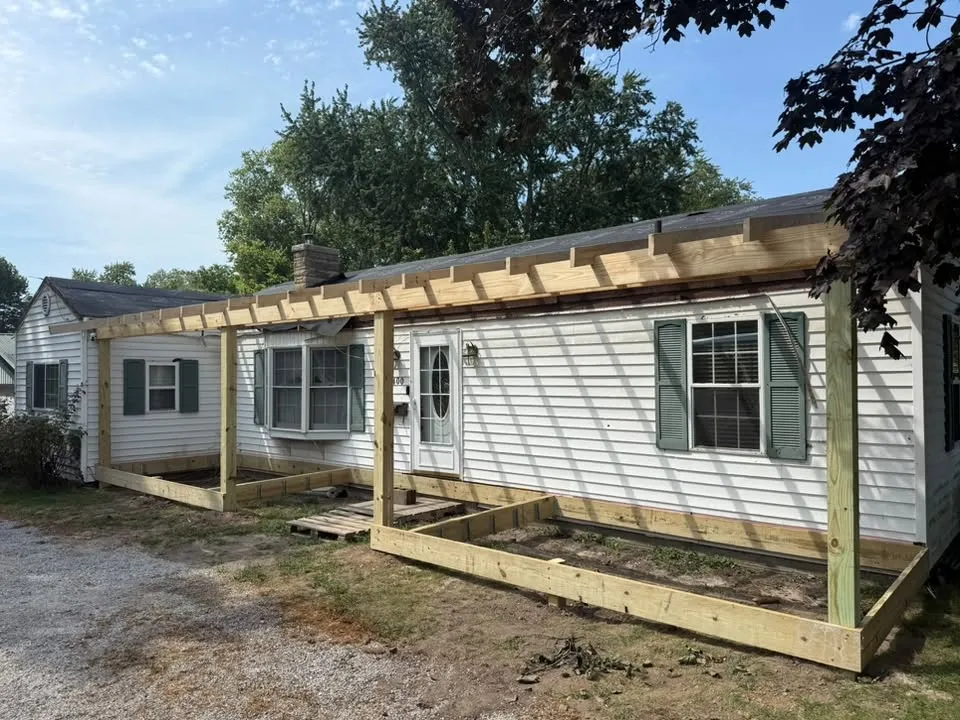 The new deck frame and posts going up across the front of the house