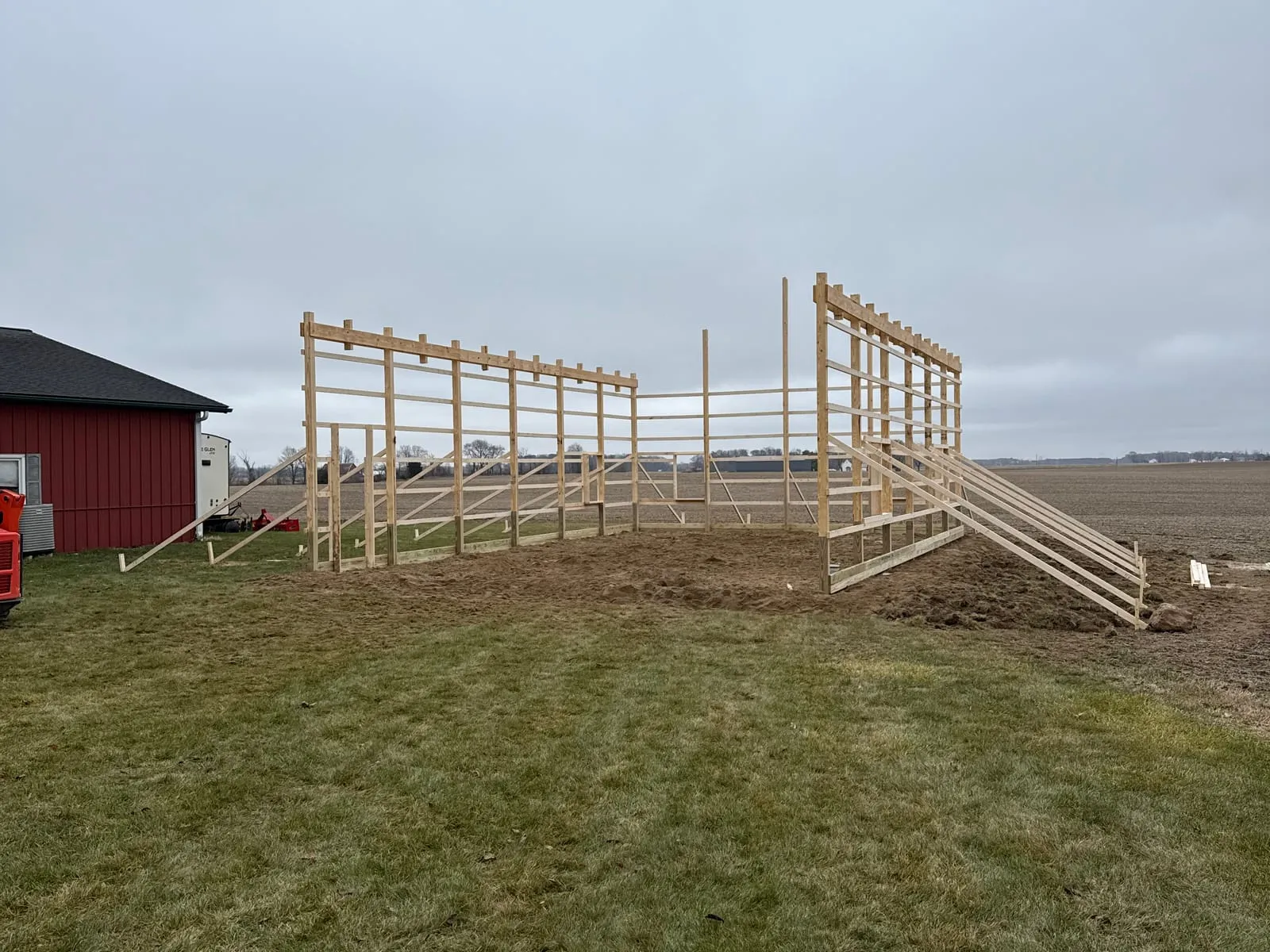 The timber post-frame of a new building erected on its concrete pad