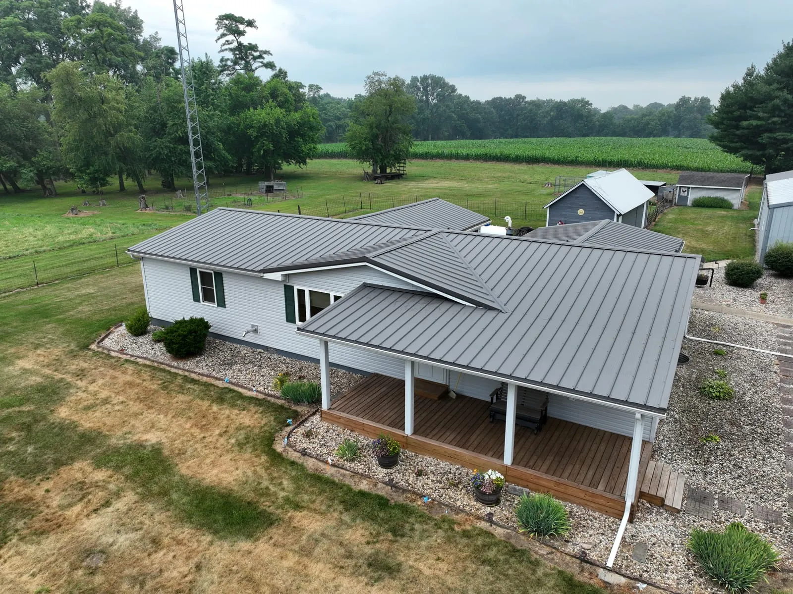 Ranch home with a charcoal standing-seam metal roof and covered porch