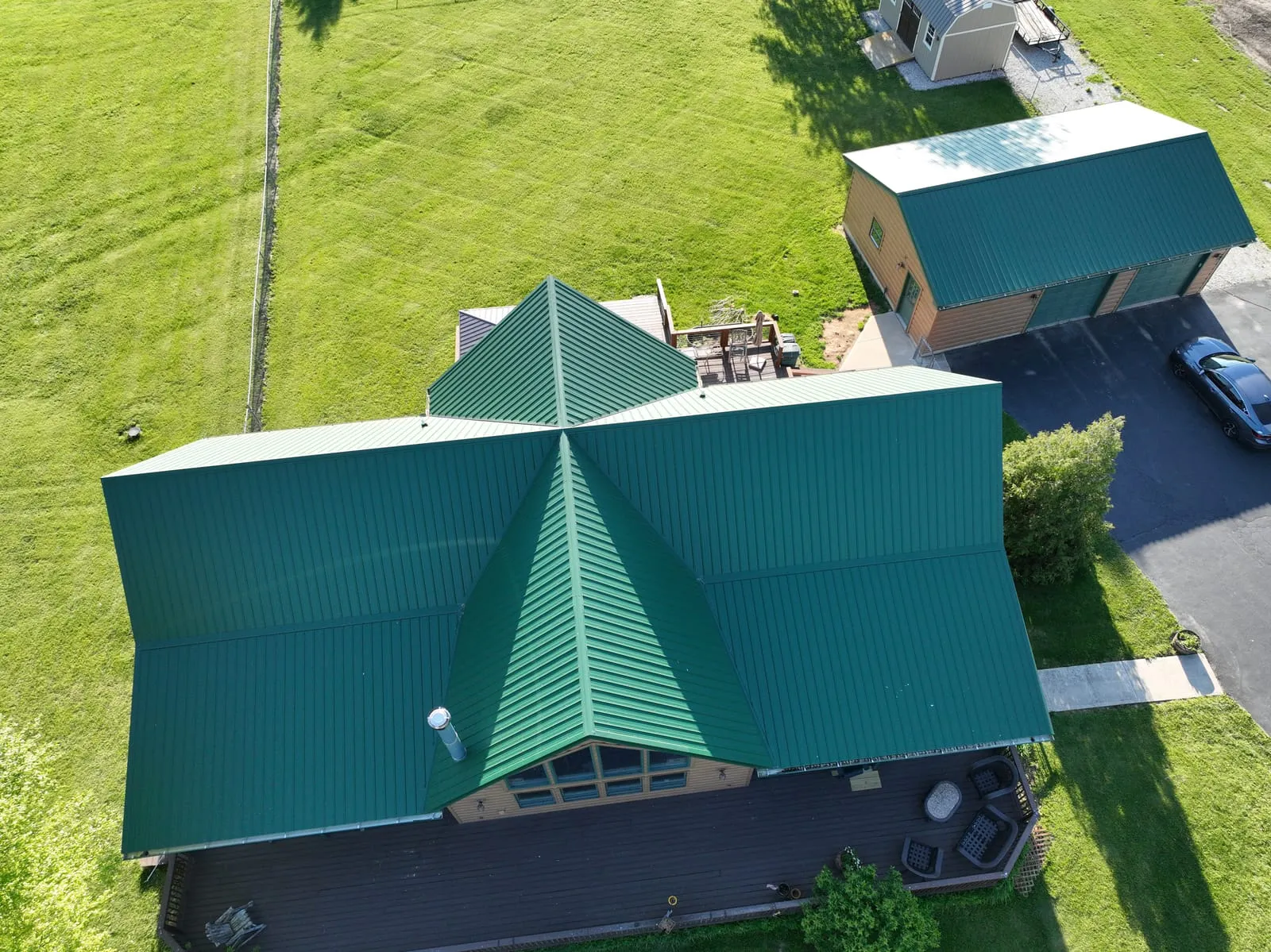 Home with a deep green standing-seam metal roof