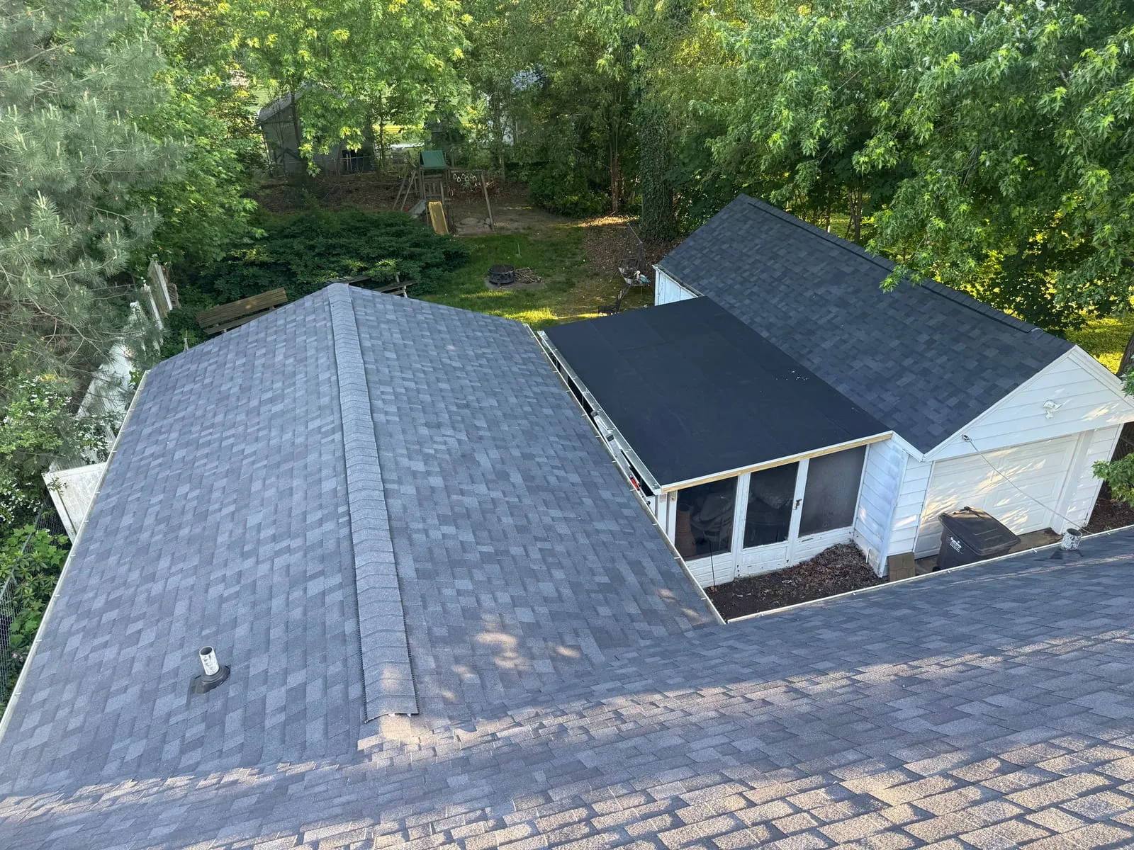 Charcoal architectural shingle roof on a two-story home with a circular driveway